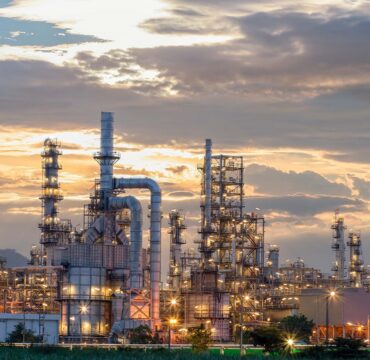 Oil refinery plant from industry zone, Aerial view oil and gas industrial, Refinery factory oil storage tank and pipeline steel at night.;