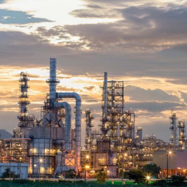 Oil refinery plant from industry zone, Aerial view oil and gas industrial, Refinery factory oil storage tank and pipeline steel at night.; Shutterstock ID 1683847615; Purchase Order: CT